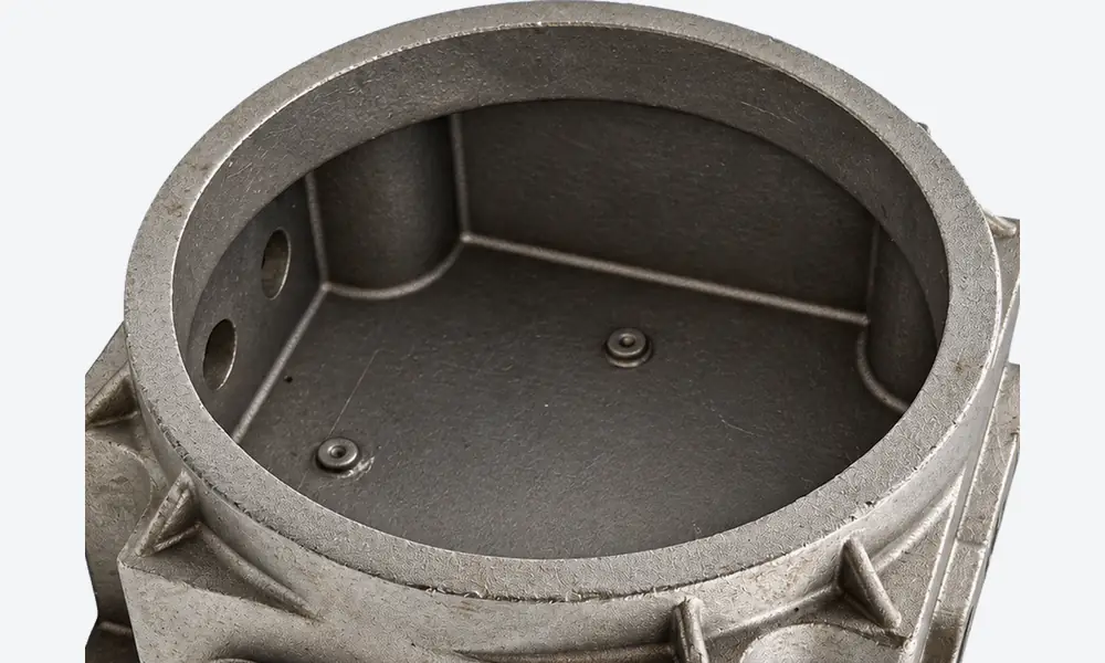 View through the circular mouth showing the housing cavity, closed base, rounded inner corners and small bosses.