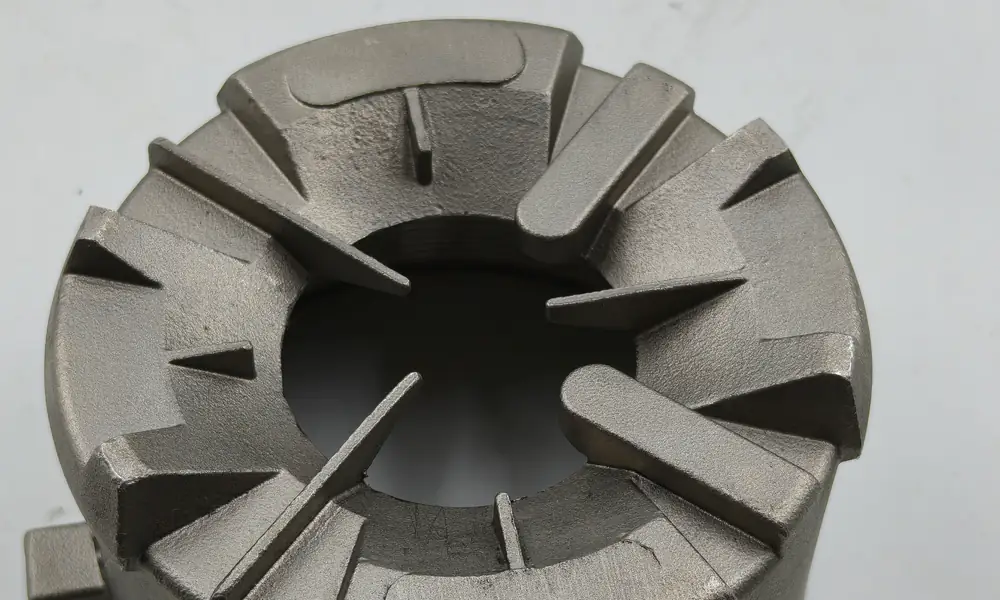 Close view of the tapered fins cast integrally around the CF8M housing opening.