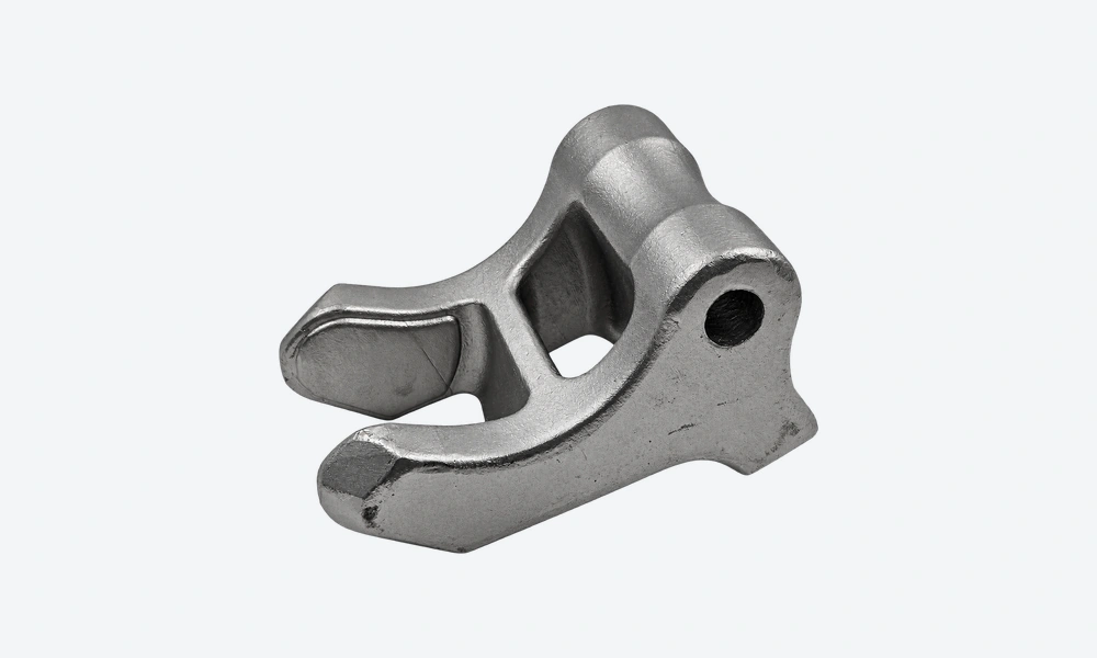 Stainless steel fork casting with curved arms, a connecting bridge and a transverse hole in the rear body.